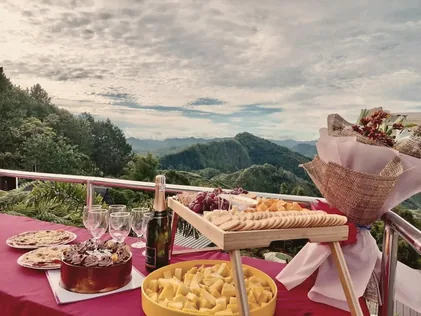 Mountain-view celebration setup with champagne and cake at New Year's Peak Resort