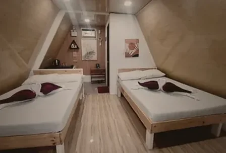 Unique A-frame house interior with triangular ceiling design at New Year's Peak Resort