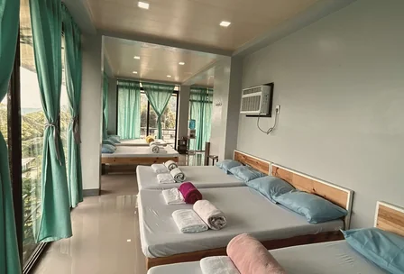 Modern glass-walled house interior with mountain view beds at New Year's Peak