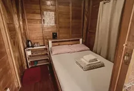 Rustic wood house cabin interior with warm natural wood walls at New Year's Peak Resort